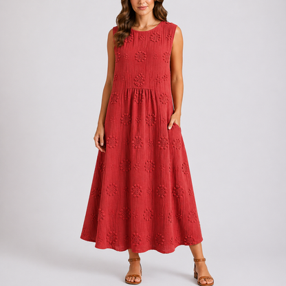 Red - Sleeveless midaxi smock dress featuring tufted floral patterns, a round neckline, and side pockets, styled on a model against a plain background.