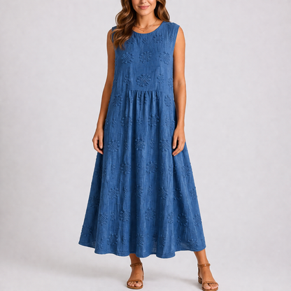 Navy - Sleeveless midaxi smock dress featuring tufted floral patterns, a round neckline, and side pockets, styled on a model against a plain background.