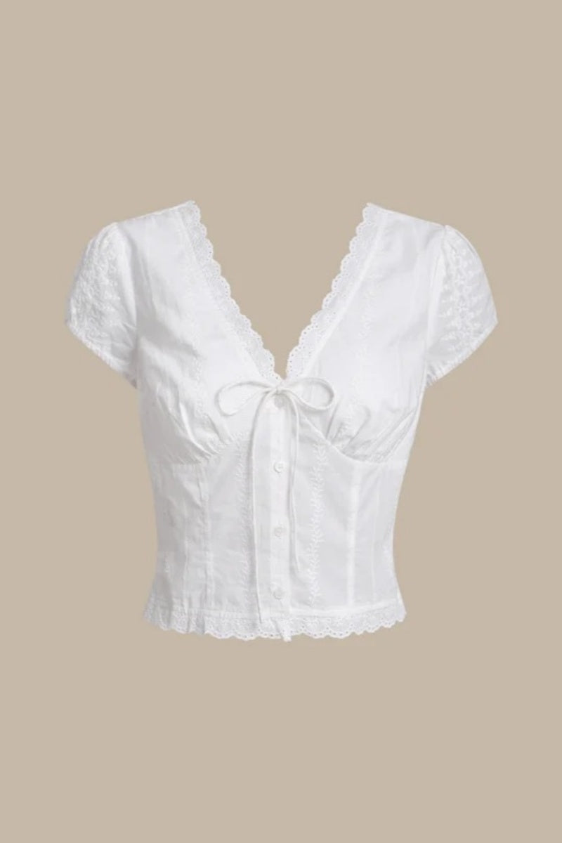 White - Women's white short-sleeve tailored blouse featuring intricate floral embroidery, a deep V-neckline with scalloped lace trim, and a delicate tie-front detail at the bust.