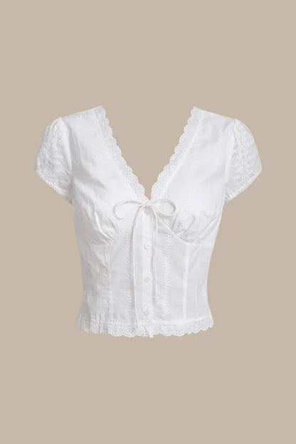 White - Women's white short-sleeve tailored blouse featuring intricate floral embroidery, a deep V-neckline with scalloped lace trim, and a delicate tie-front detail at the bust.