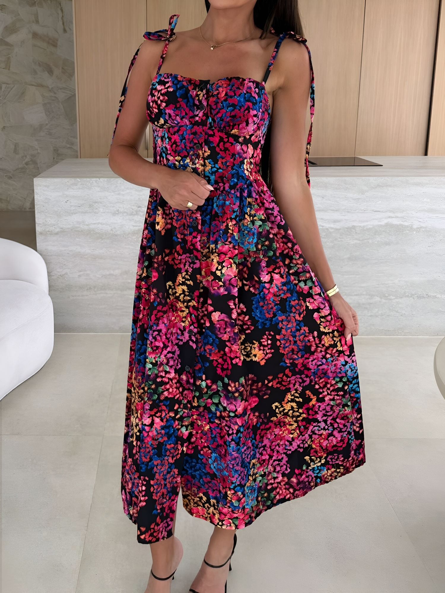 Black - Woman modelling a printed A-line midi dress featuring a sweetheart neckline, button-down bodice, and adjustable tie-straps.