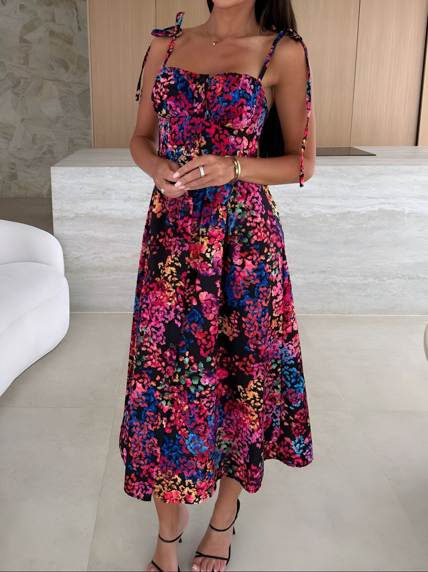 Black - Woman modelling a printed A-line midi dress featuring a sweetheart neckline, button-down bodice, and adjustable tie-straps.