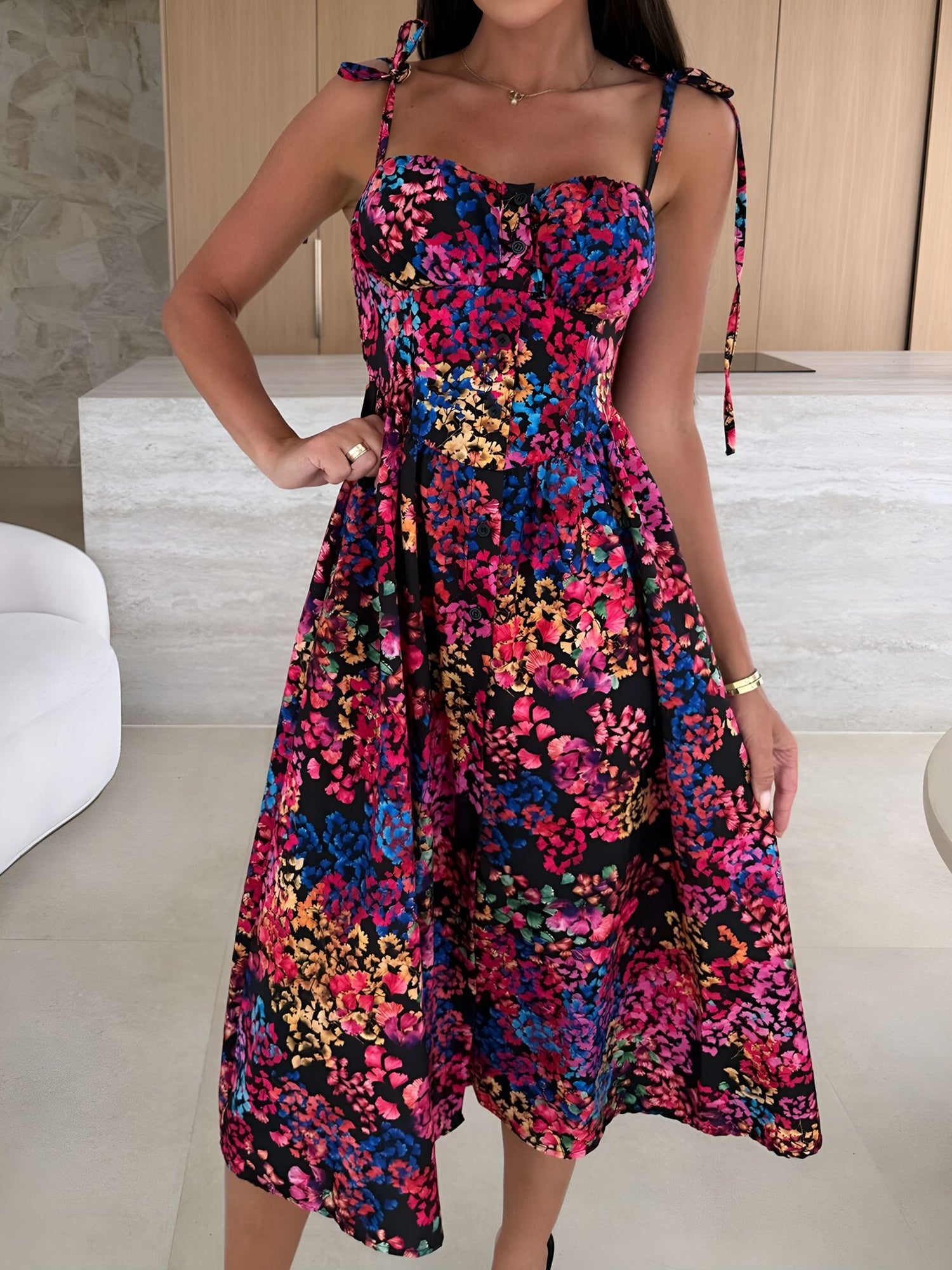 Black - Woman modelling a printed A-line midi dress featuring a sweetheart neckline, button-down bodice, and adjustable tie-straps.