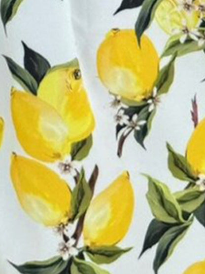 Yellow - Woman modelling a printed A-line midi dress featuring a sweetheart neckline, button-down bodice, and adjustable tie-straps.