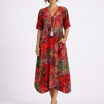 Red - Model wearing a woven abstract-print V-neck relaxed midi dress with short sleeves and side pockets