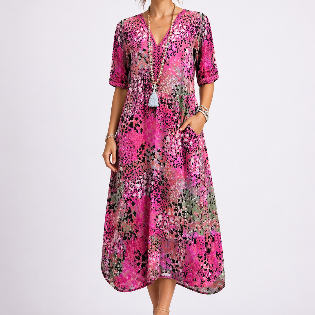 Pink - Model wearing a woven abstract-print V-neck relaxed midi dress with short sleeves and side pockets