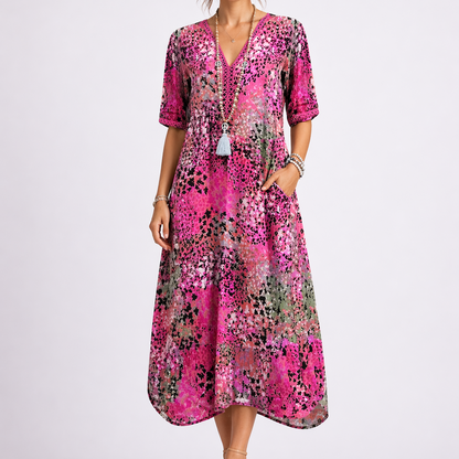 Pink - Model wearing a woven abstract-print V-neck relaxed midi dress with short sleeves and side pockets