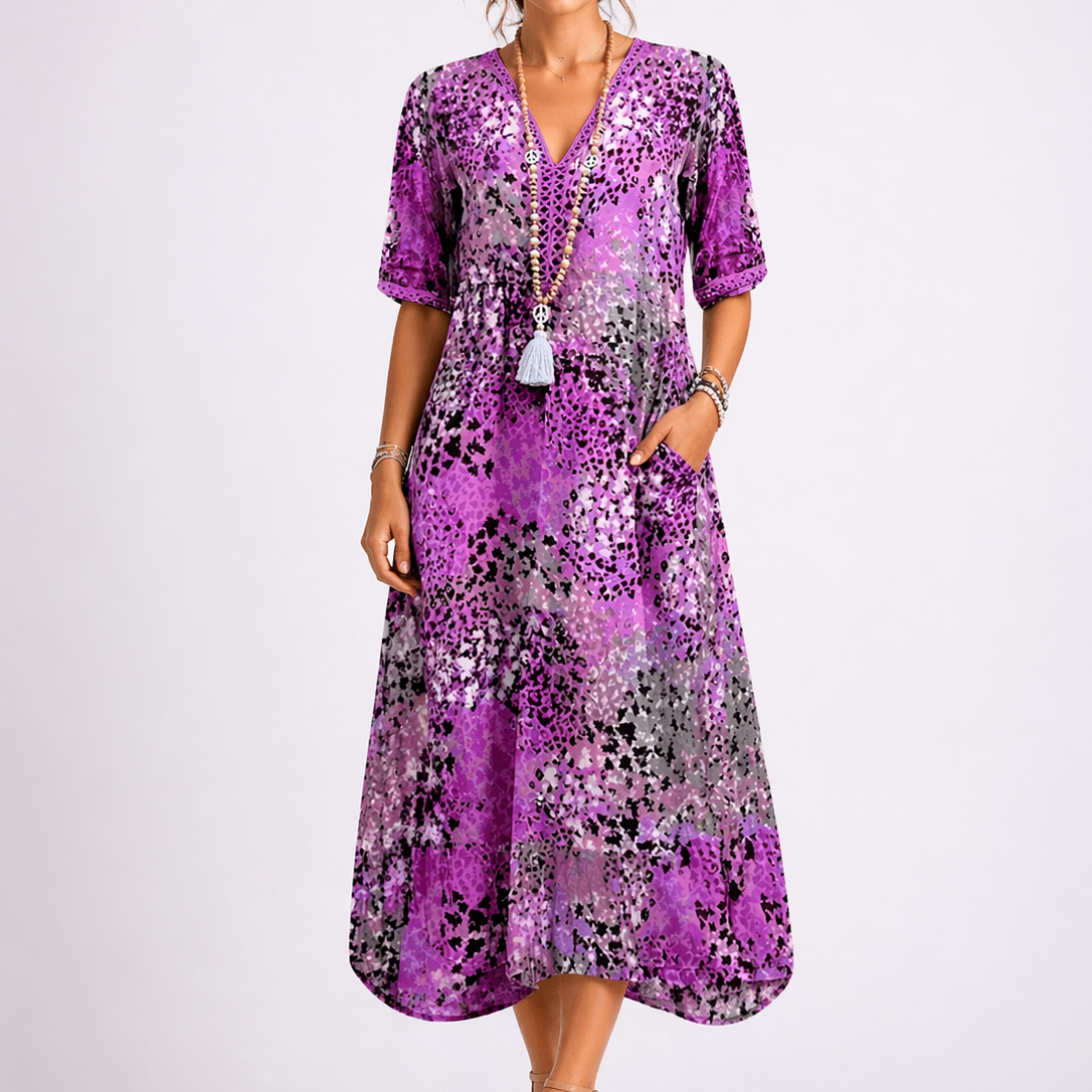 Purple - Model wearing a woven abstract-print V-neck relaxed midi dress with short sleeves and side pockets