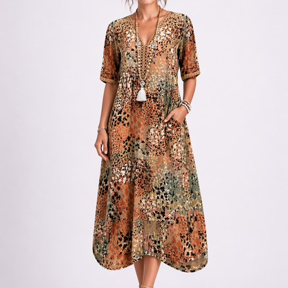 Sand & Beige - Model wearing a woven abstract-print V-neck relaxed midi dress with short sleeves and side pockets