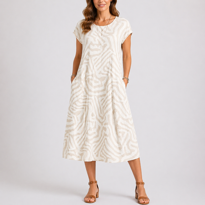 White - Woman wearing a woven abstract patterned short-sleeve midi dress with side pockets.