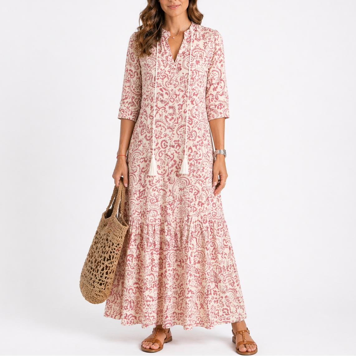 Red - Model wearing a woven geometric ikat pattern maxi dress featuring a V-neckline with tassel ties, 3/4 sleeves, and a tiered hemline.