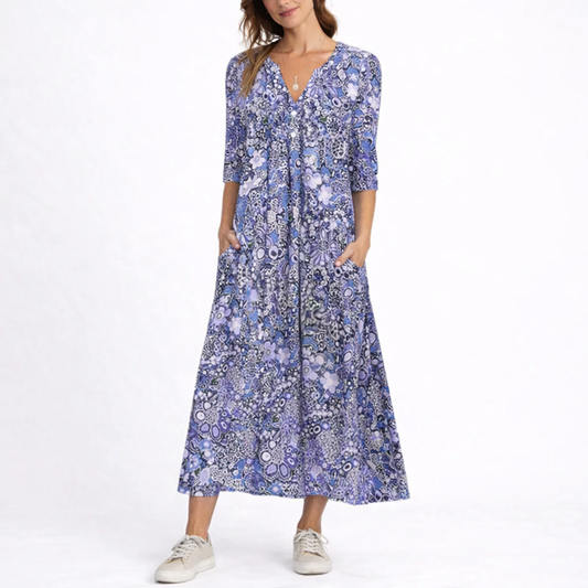 Blue - Woman wearing a woven floral 3/4-sleeve relaxed midaxi dress with a V-neckline, button placket, and side pockets