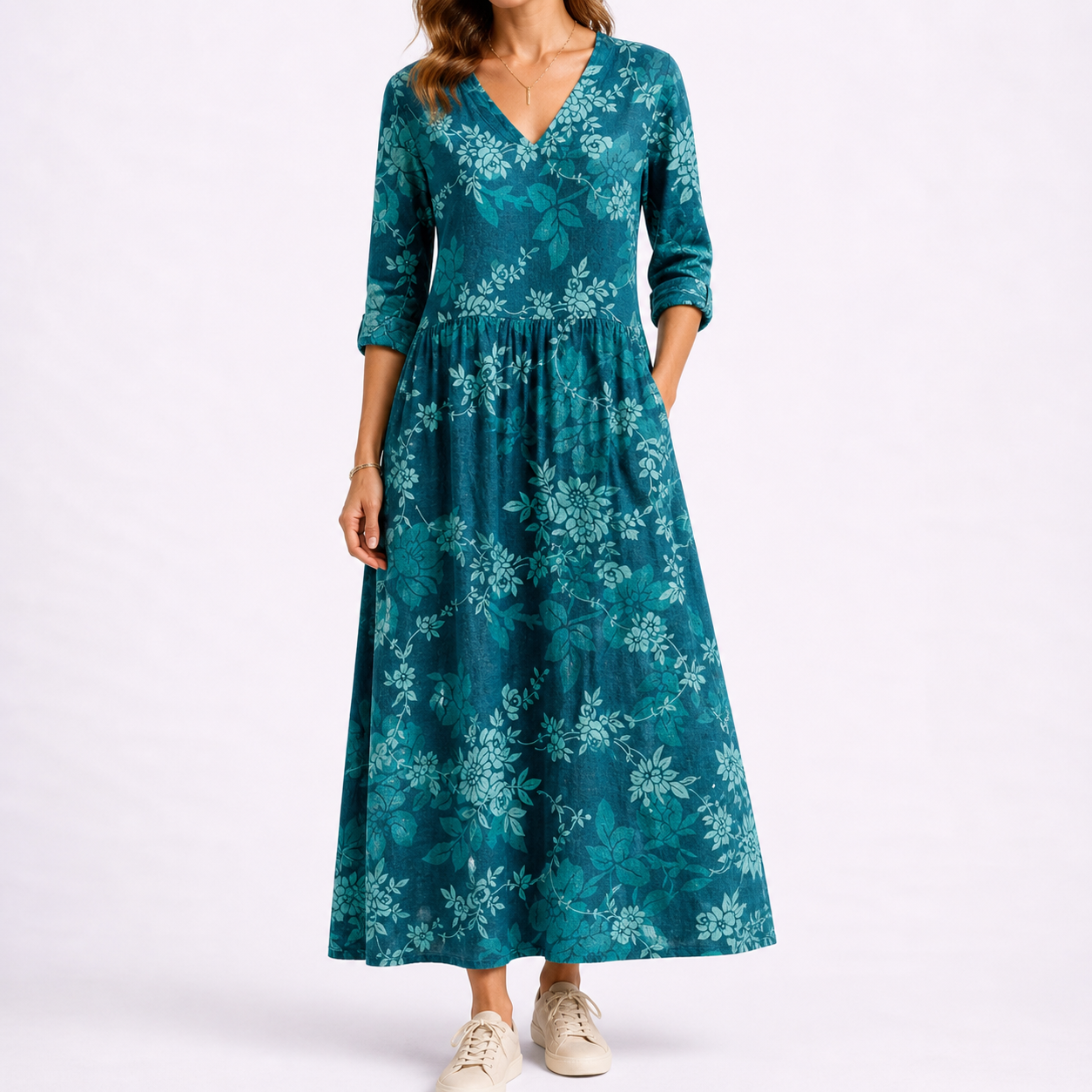 Blue - Woman wearing a woven floral midaxi dress with a V-neckline, 3/4-sleeves, and a gathered waist with side pockets, styled with trainers.