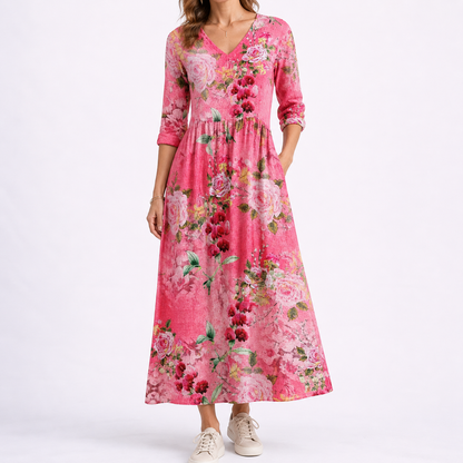 Red - Woman wearing a woven floral midaxi dress with a V-neckline, 3/4-sleeves, and a gathered waist with side pockets, styled with trainers.