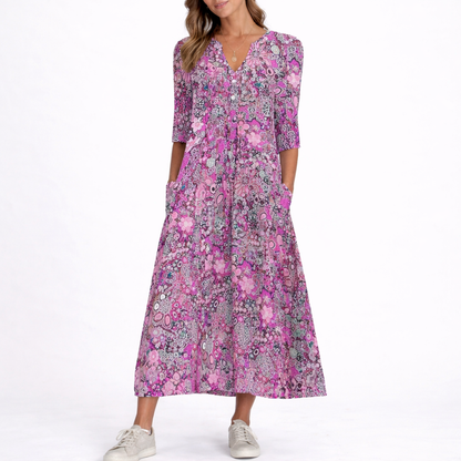 Purple - Woman wearing a woven floral 3/4-sleeve relaxed midaxi dress with a V-neckline, button placket, and side pockets