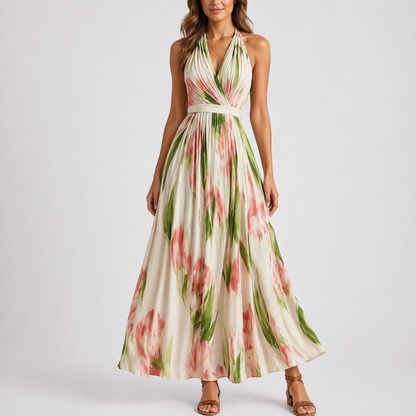 Floral - Woman wearing a flowing floral halter-neck maxi dress with a gathered bodice and sweeping A-line skirt