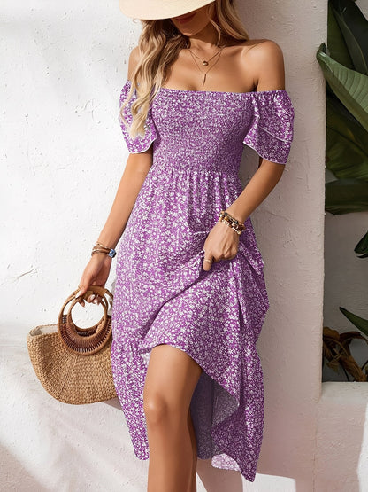 Blue - Woman wearing a woven floral square-neck midi dress with a smocked bodice, flutter sleeves, and a tiered skirt, styled with a straw hat and woven bag.