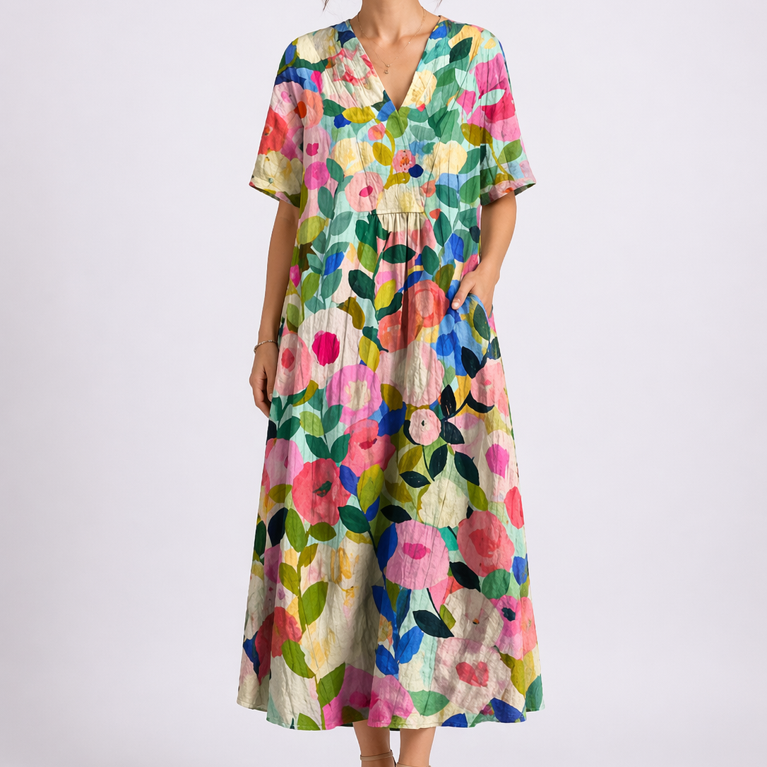 Floral - Woman wearing a woven floral V-neck maxi dress with short sleeves and side pockets.