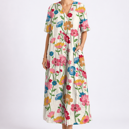 Multicolor - Woman wearing a woven floral V-neck maxi dress with short sleeves and side pockets.