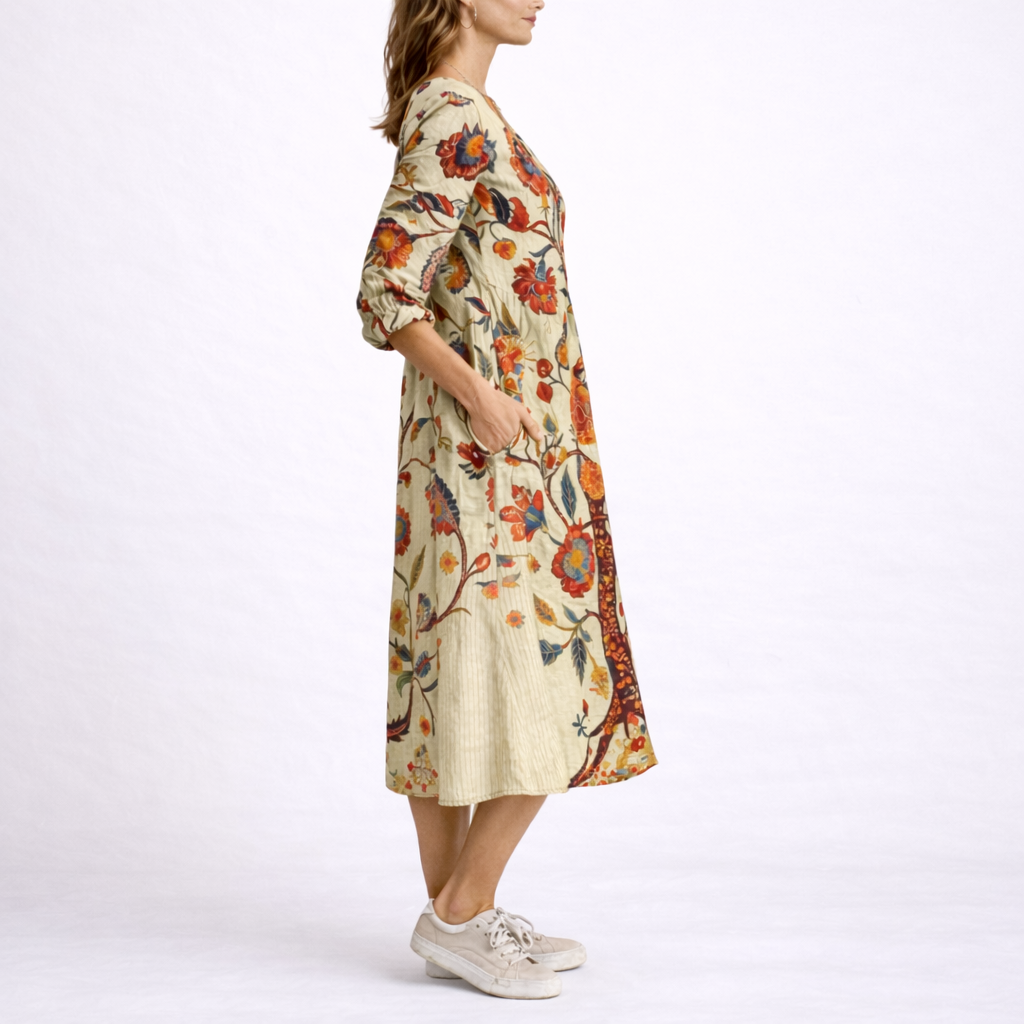 Beige - Woman wearing a woven floral V-neck midi dress with three-quarter sleeves and side pockets, styled with trainers and a straw bag.