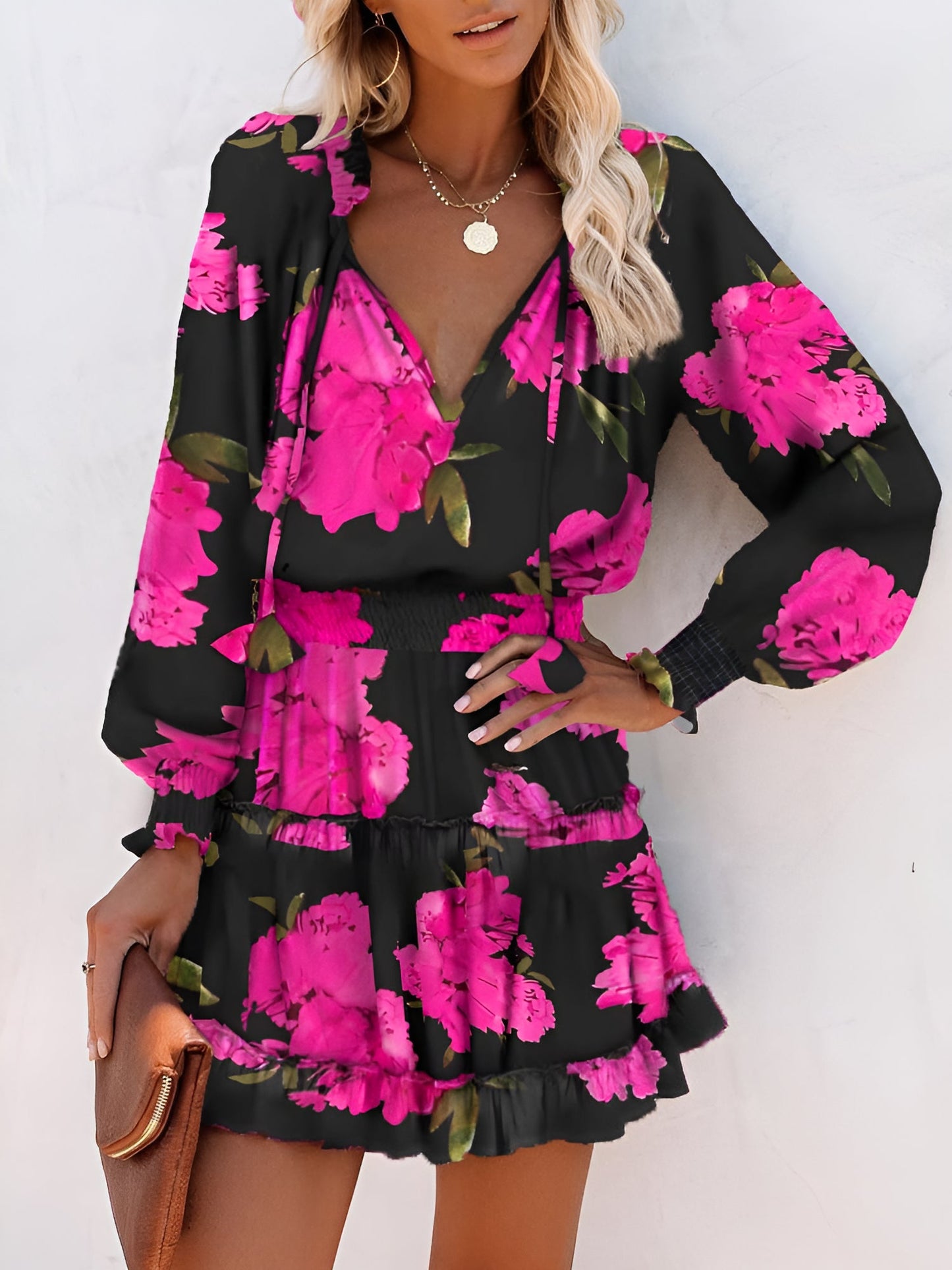 Rose Red - Woman wearing a woven floral V-neck mini dress with long sleeves, smocked waist, and tiered ruffle skirt.