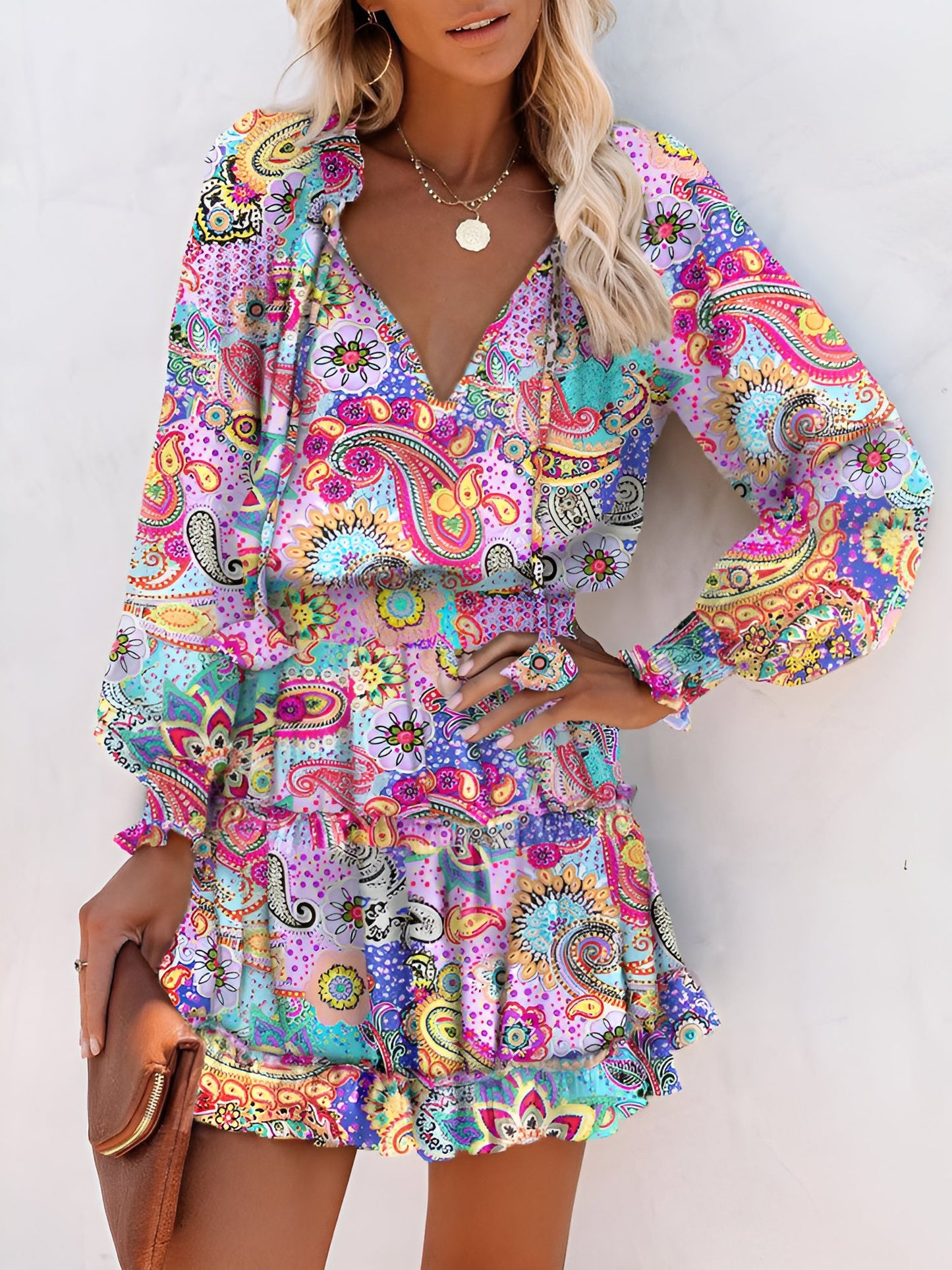 Light Purple - Woman wearing a woven floral V-neck mini dress with long sleeves, smocked waist, and tiered ruffle skirt.