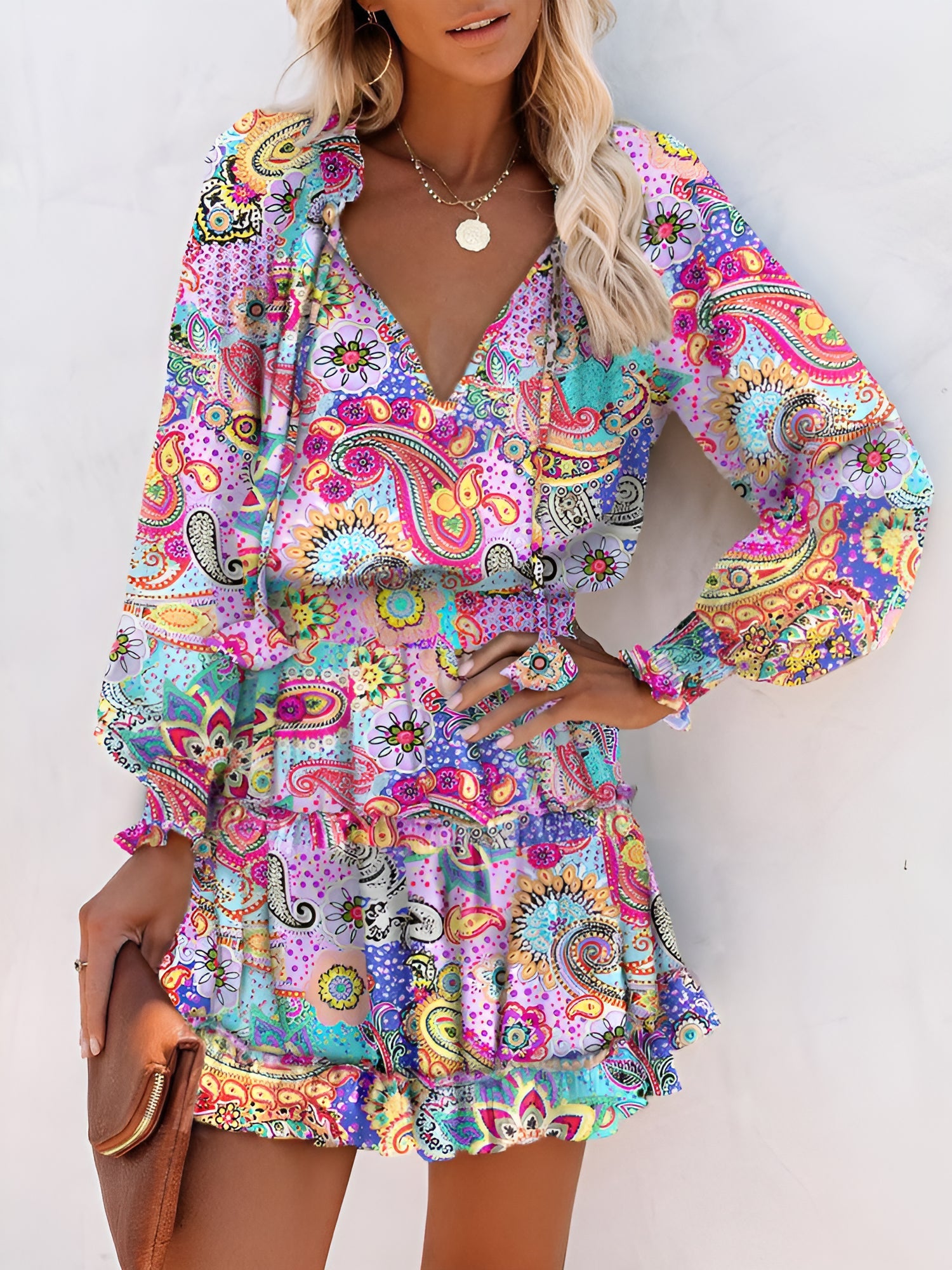 Light Purple - Woman wearing a woven floral V-neck mini dress with long sleeves, smocked waist, and tiered ruffle skirt.