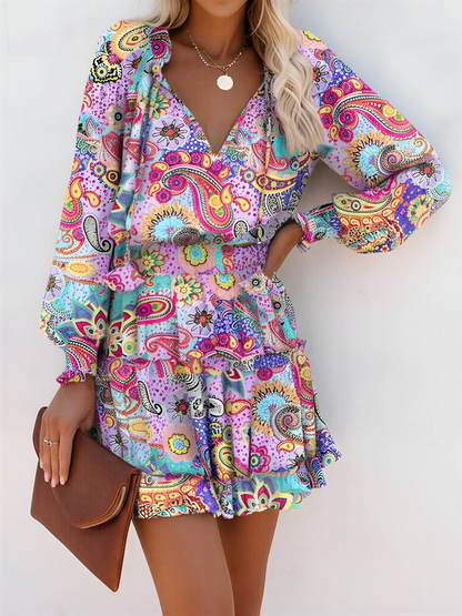 Light Purple - Woman wearing a woven floral V-neck mini dress with long sleeves, smocked waist, and tiered ruffle skirt.