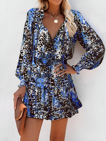 Blue - Woman wearing a woven floral V-neck mini dress with long sleeves, smocked waist, and tiered ruffle skirt.