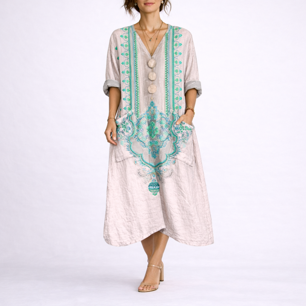 Pink & Green - Model wearing a woven paisley print relaxed midaxi dress with a v-neckline, rolled sleeves, large front buttons, and patch pockets.