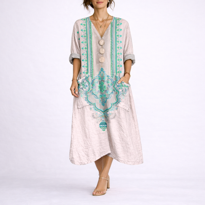 Pink & Green - Model wearing a woven paisley print relaxed midaxi dress with a v-neckline, rolled sleeves, large front buttons, and patch pockets.