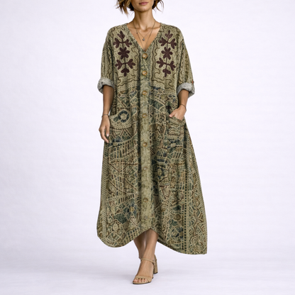 Green - Model wearing a woven paisley print relaxed midaxi dress with a v-neckline, rolled sleeves, large front buttons, and patch pockets.