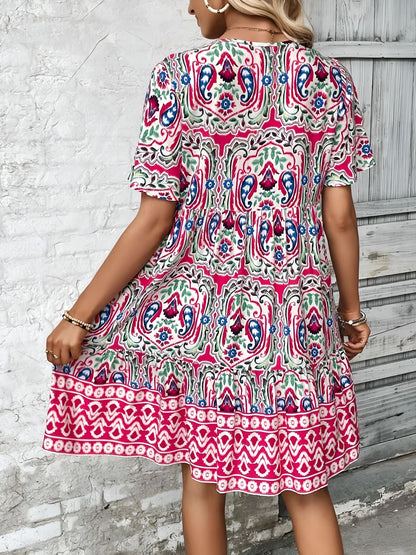 Rose Red - Woman wearing a woven paisley print V-neck tiered mini dress with short sleeves and front button detailing.