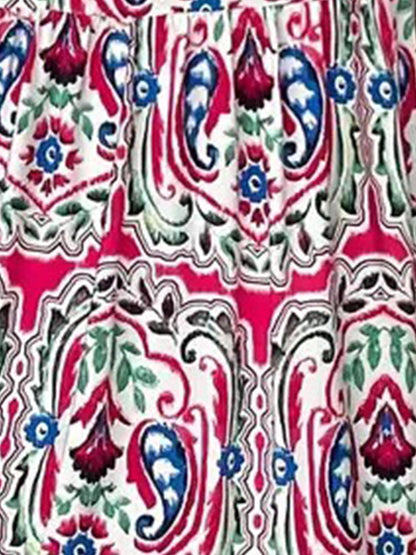 Rose Red - Woman wearing a woven paisley print V-neck tiered mini dress with short sleeves and front button detailing.