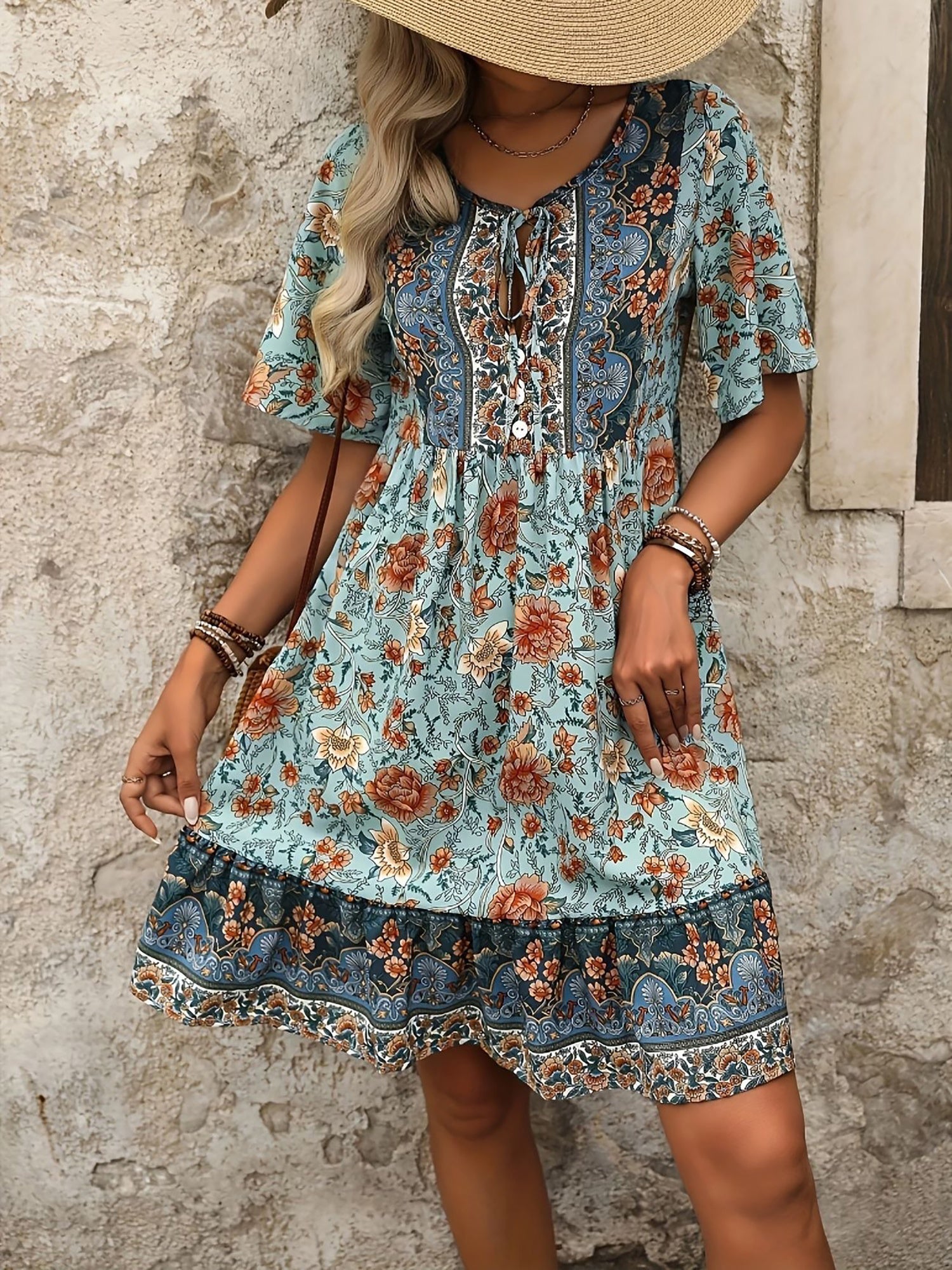 Mixed Colors - Woman wearing a woven paisley print V-neck tiered mini dress with short sleeves and front button detailing.