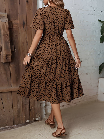 Leopard - Woman wearing a spot pattern V-neck tiered midi dress with short sleeves and side pockets, standing in an architectural hallway.