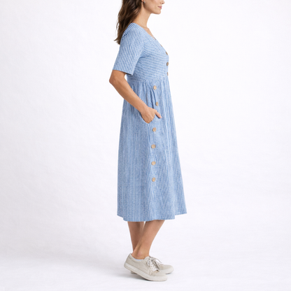 Blue - Woman wearing a striped short-sleeve midi dress with asymmetric wooden button detailing and side pockets, standing against a white background.